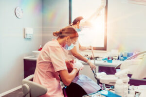dental hygienist working with patient